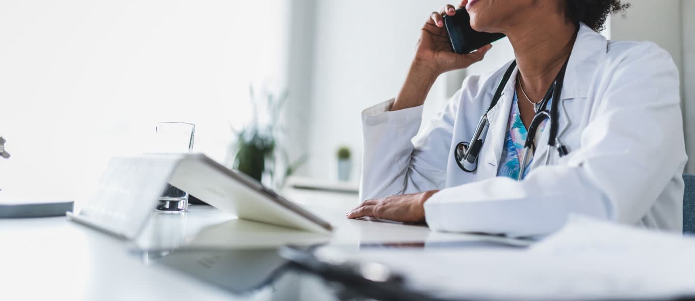 A healthcare professional talking on a phone